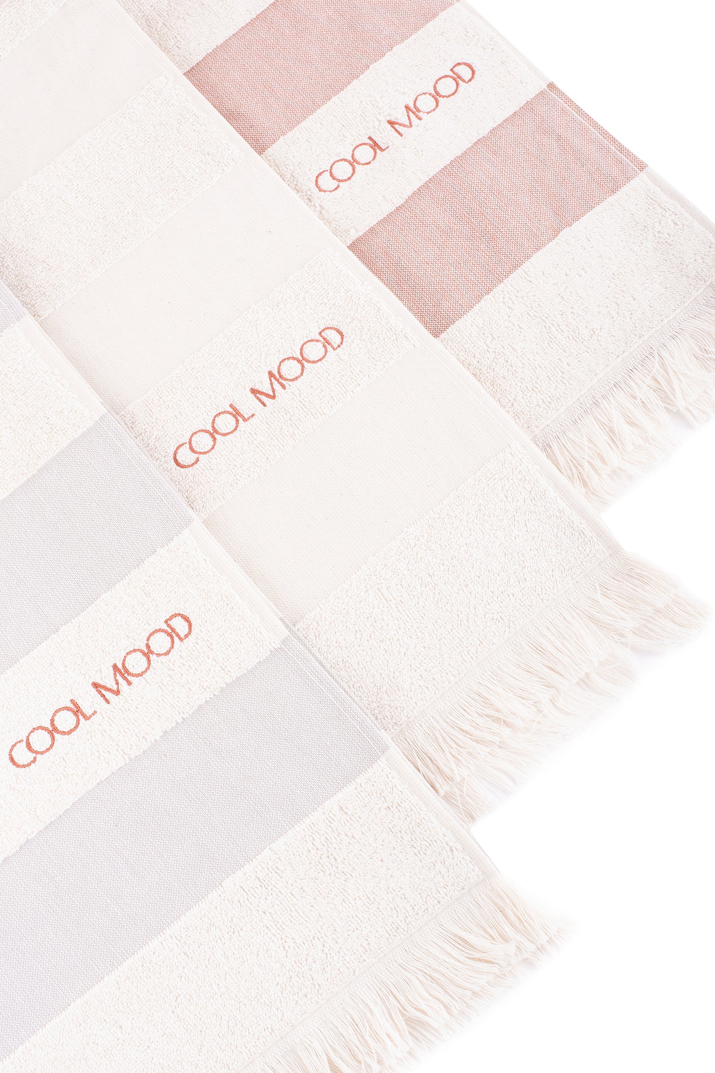 Available in three different colors: grey, natural shade and rust. All with soft terry stripes, eyelash fringing detail and embroidery in rust.